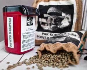 Pictured is Power Roaster, Pak Kopi branded coffee beans with Asher Yaron's photo on the coffee sack label.